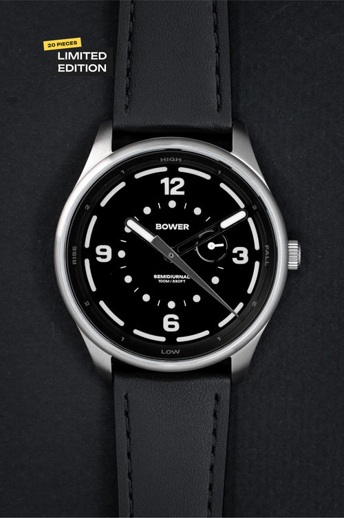 Midnight Black Tide Seeker watch by Bower with black leather strap, displayed against a black background with a yellow “20 Pieces Limited Edition” label. Minimalist tool watch designed for tide tracking and coastal exploration.