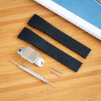 Black watch CTS FKM strap with metal clasp and tools on a wooden surface