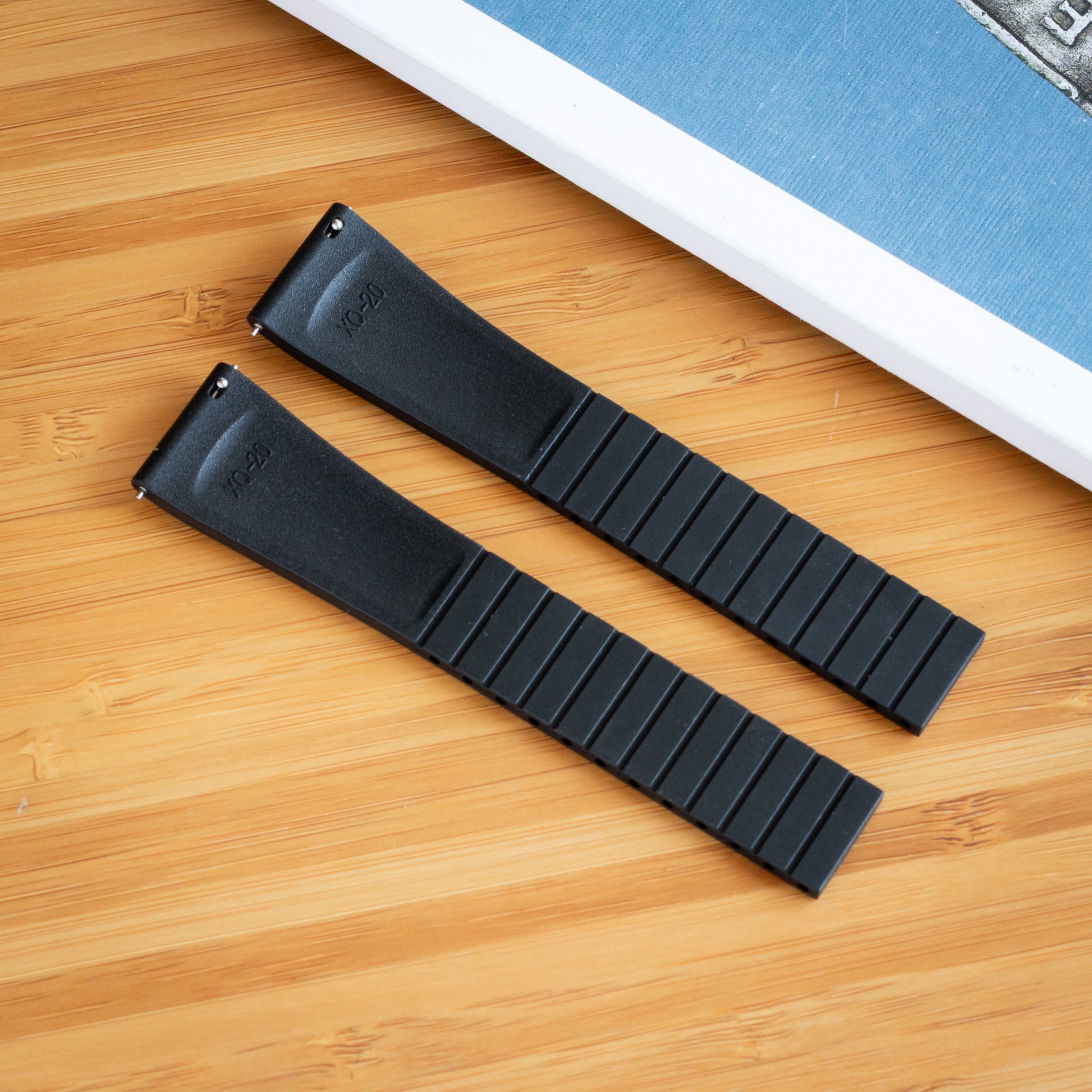 Two black bower watch CTS FKM Rubber strap on a wooden surface