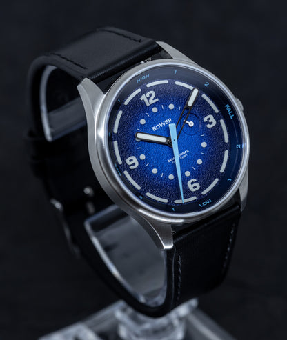 a blue dial bower watch on black background