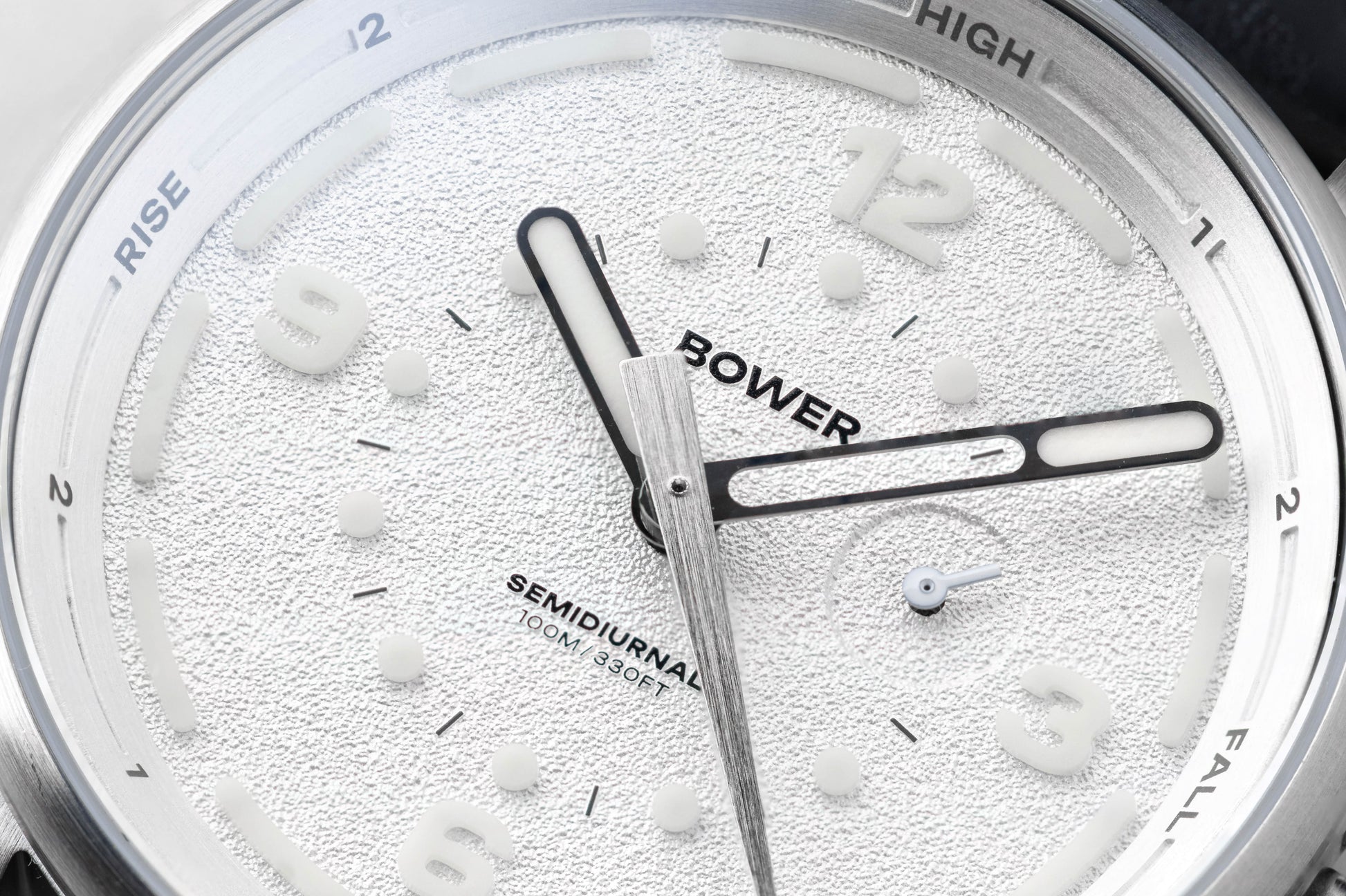 Close-up of Coral White Tide Seeker watch face by Bower, featuring textured dial, semidiurnal tide markings, and 100M water resistance. Designed for precise tide tracking and coastal adventure.