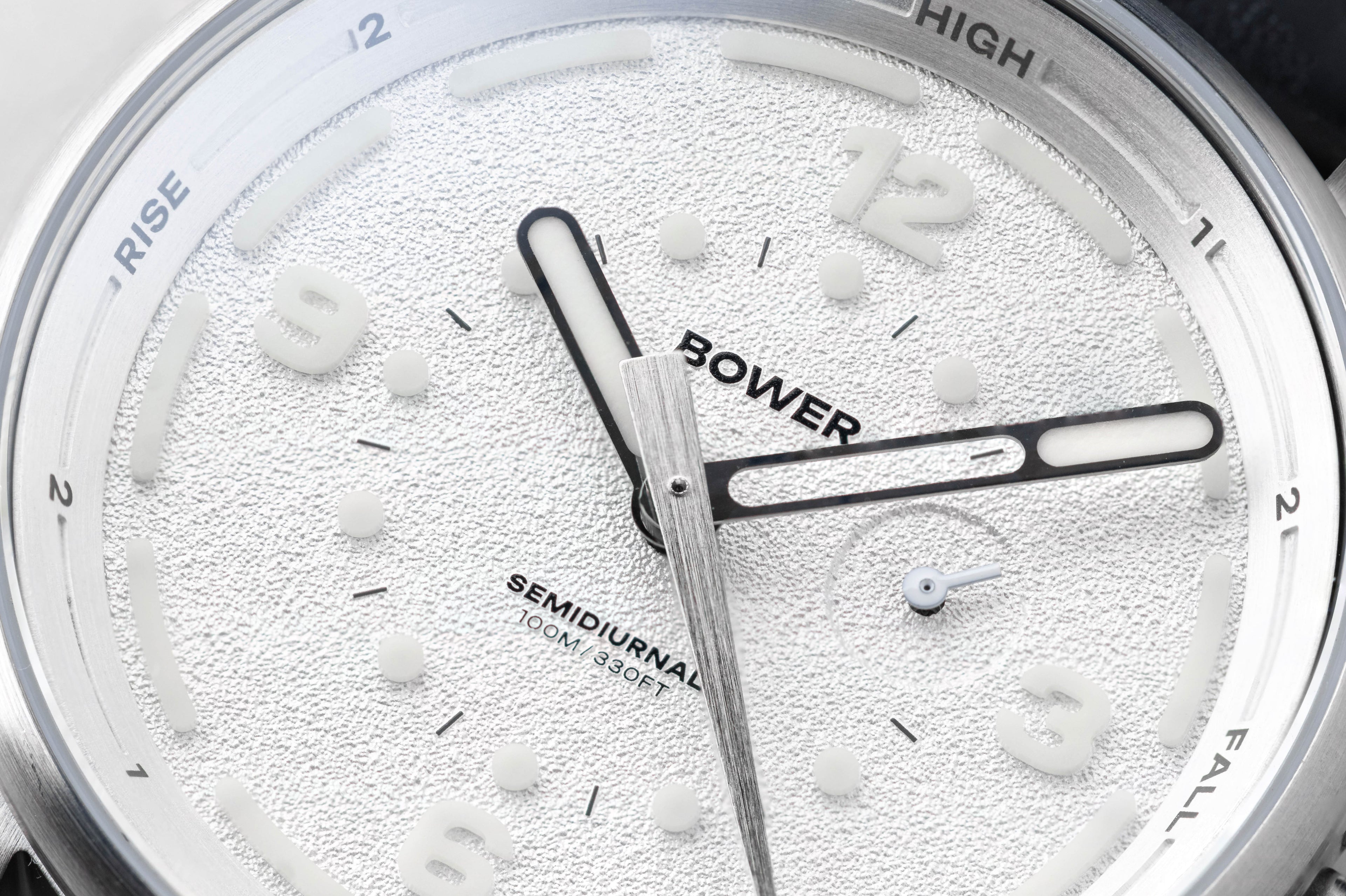 Close-up of Coral White Tide Seeker watch face by Bower, featuring textured dial, semidiurnal tide markings, and 100M water resistance. Designed for precise tide tracking and coastal adventure.
