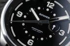 Close-up of Midnight Black Tide Seeker watch face by Bower, featuring luminous hands, semidiurnal tide indicator, and 100M water resistance. Precision tool watch designed for ocean living.